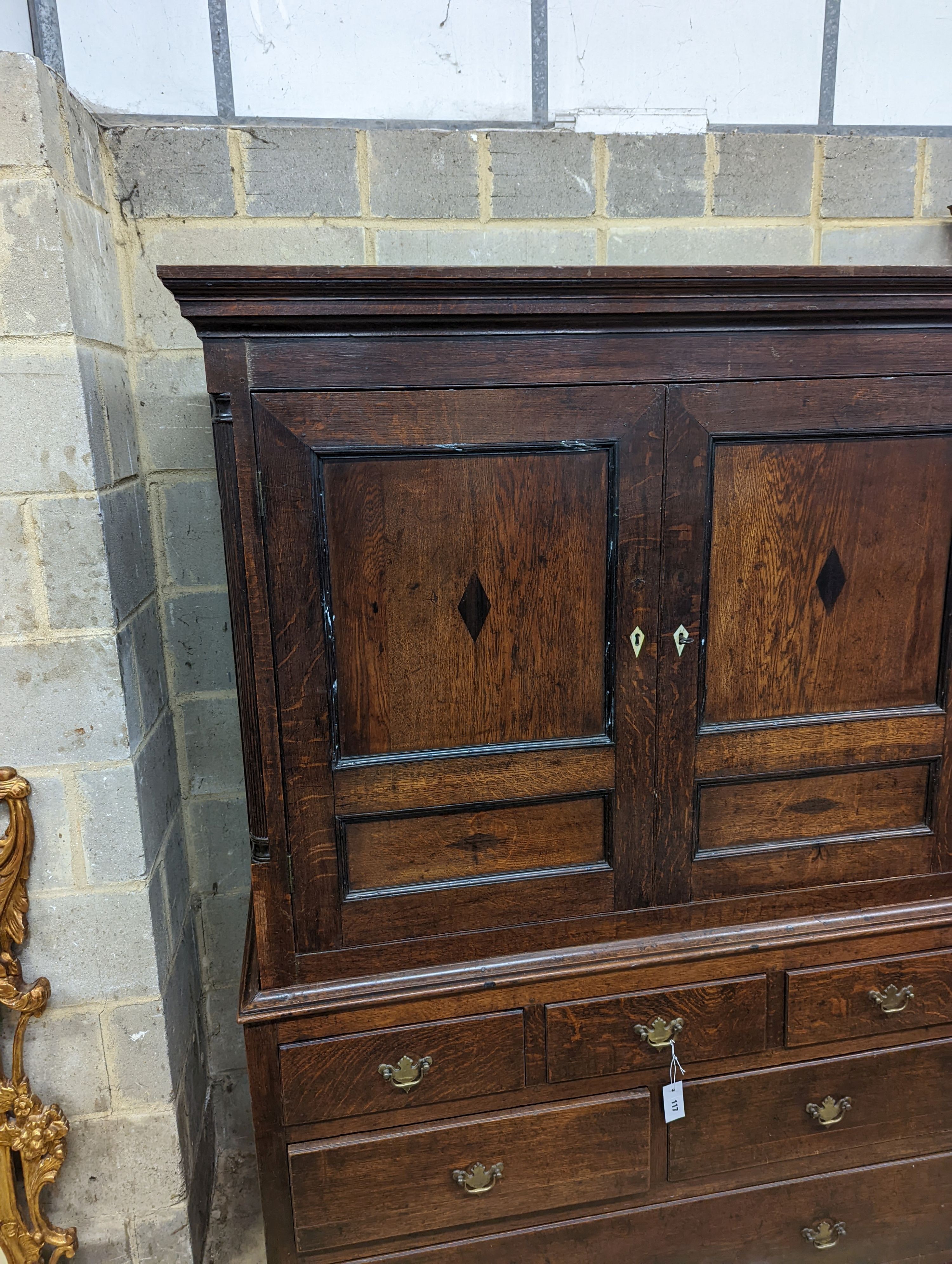 A George III oak press cupboard fitted six drawers, width 132cm, depth 54cm, height 187cm